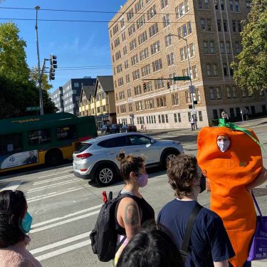Person in carrot costume leading tour